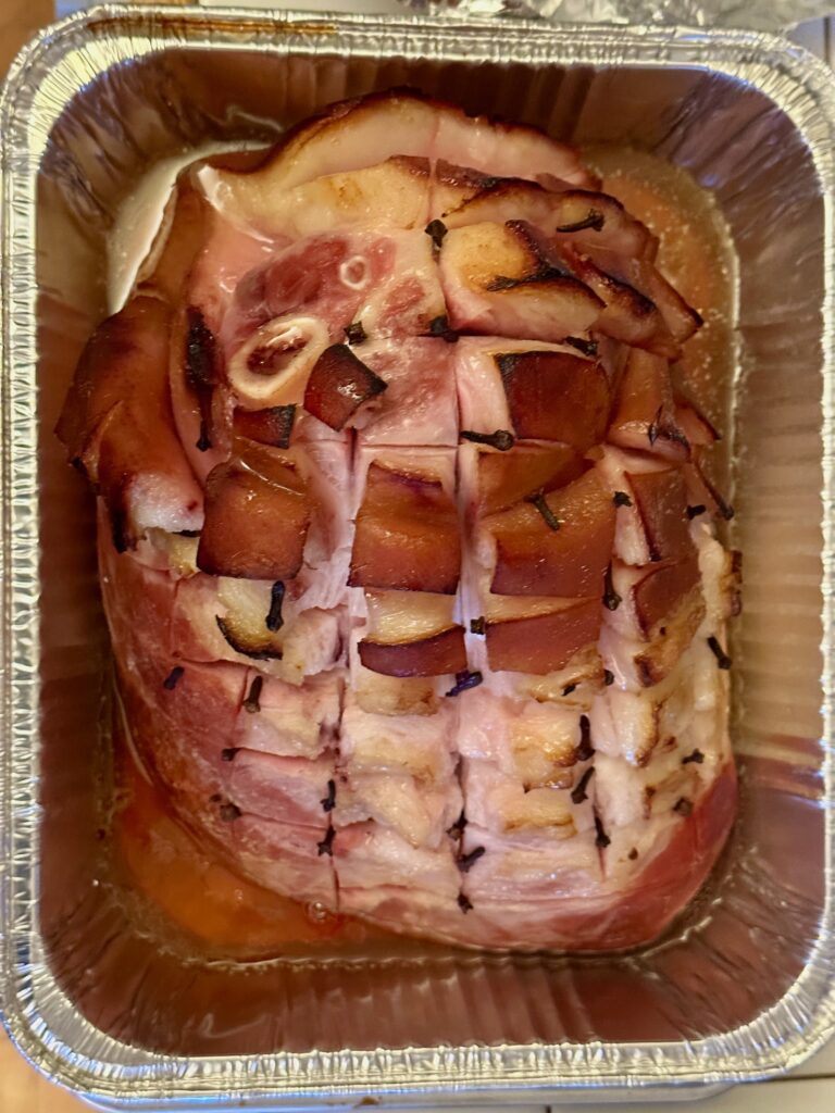 Roasted bone-in ham finished in an aluminum pan