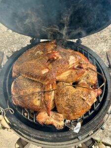 Quartered turkey smoked on the grill of a Big Green Egg Minimax grill