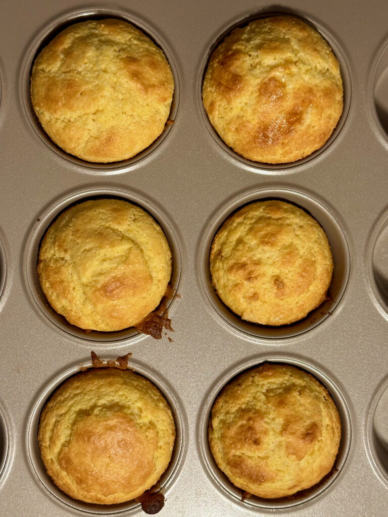 Baked cornbread muffins in a muffin pan