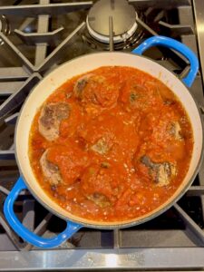 Homemade meatballs in a spaghetti sauce in a pot on the stove