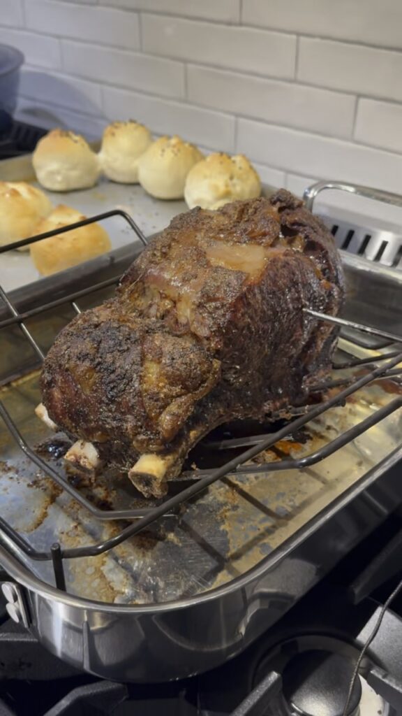 Standing rib roast cooked and in the pan on the stove