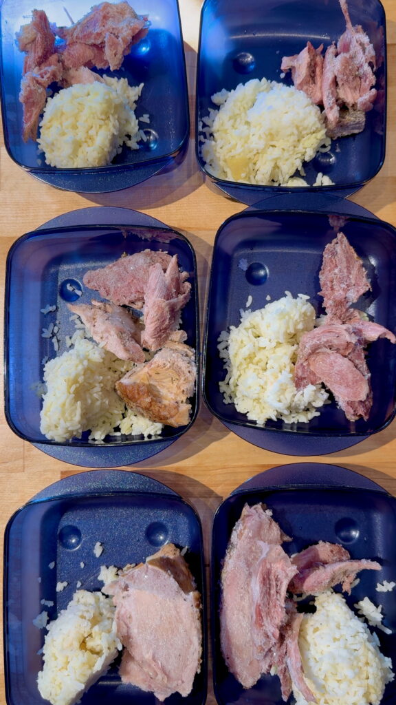 Meal prep containers with left over rice and sliced turkey