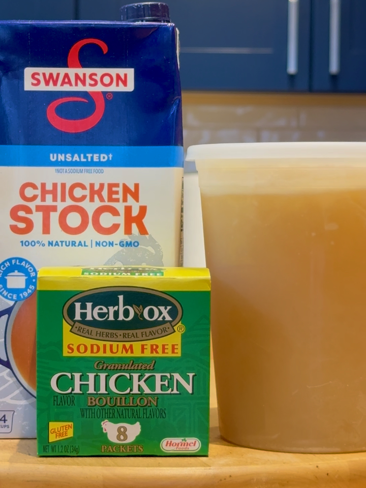 Box of unsalted chicken stock, box of sodium free chicken bouillon, container of homemade chicken stock