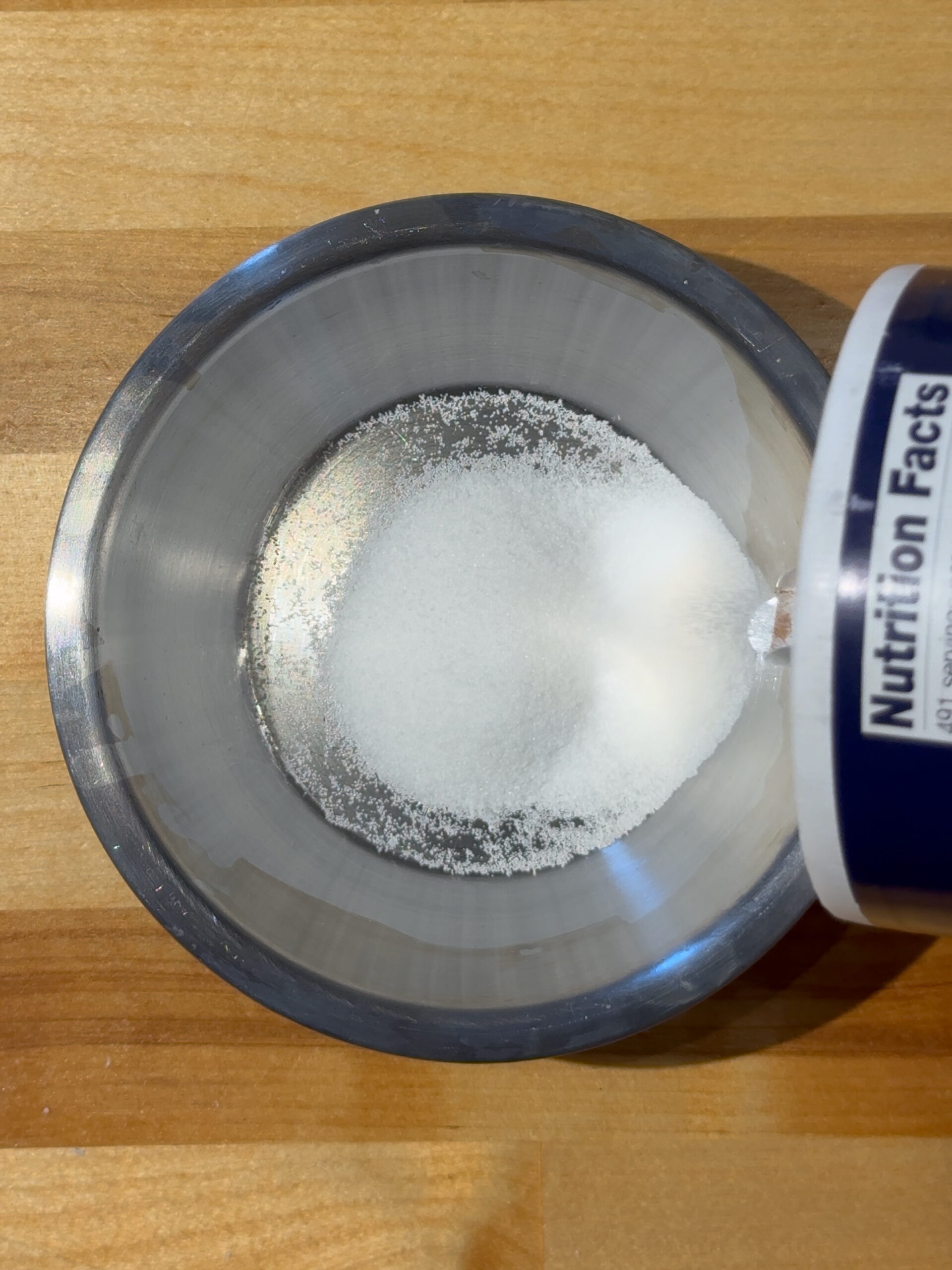 Mortons table salt being poured into a small metal dish