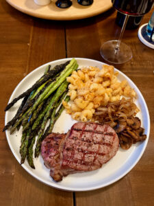 Grilled filet mignon with grilled asparagus, sauteed onions and mushrooms, and baked mac and cheese