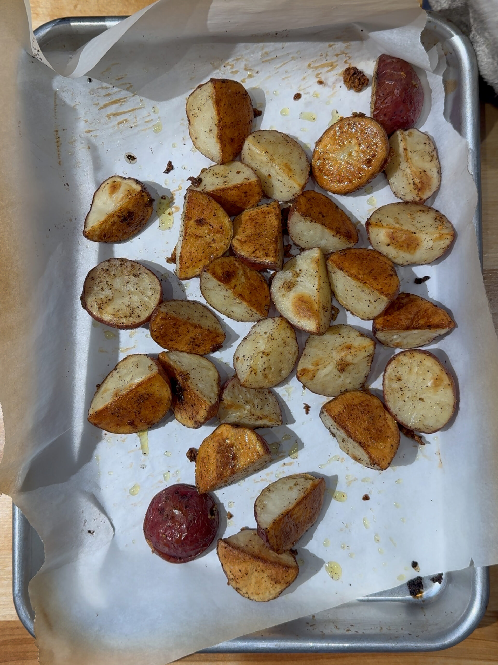 Roasted Red Potatoes on a parchment-lined quarter sheet pan
