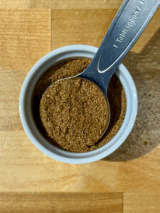 No Salt Sazon seasoning in a small white ramekin with a tablespoon measure
